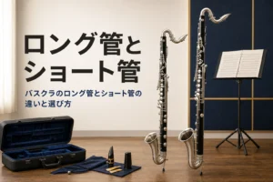 バスクラのロング管とショート管の違いを紹介する記事のアイキャッチ。床に立てた長さの違う2本のバスクラリネット